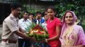 Debashree Majumder being handed over with a bouquet by a police officer
