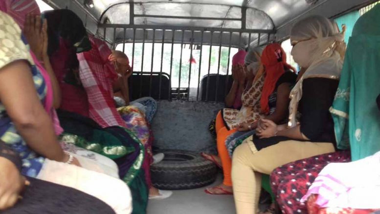 Arrested girls being taken to court in police vehicle