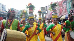 Women in colorful attire walking in procession with the Mangal Ghat in Krishnanagar on Monday morning. Picture by Pranab Debnath