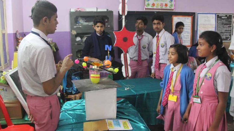 A student showing a science model at BDN school canpus