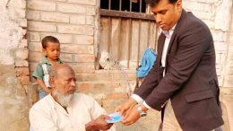 Kaliganj BDO Nazir Hossain handing over Swasthya Sathi card
