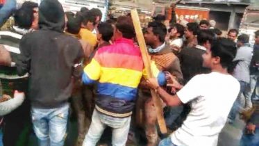 Trinamul activists with a bamboo poles in hand block the way of the BJP's motorbike rally in Plassey