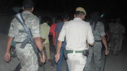 Police officers during a night patrol in the village