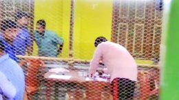 Saheb Ghosh stamping ballots inside a counting hall in Majhdia
