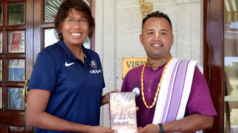 Former Indian Women's cricket team captain Jhulan Goswami receiving a 'Bhagawad Gita' from an official of Iskcon