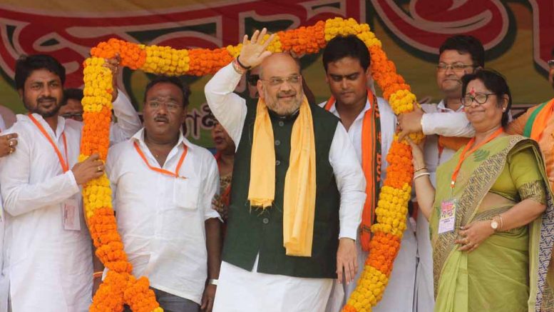 BJP President Amit Shah being welcomed with a garland at an election meeting in Kalyani on Wednesday. Picture by Abhi Ghosh