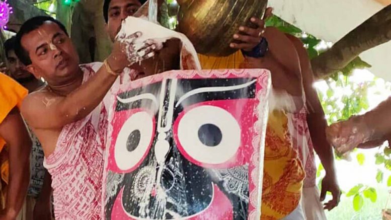 The deity of Lord Jagannath being given the bath at Rajapur temple
