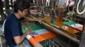 A weaver making unstitched national tricolor in Phulia, Nadia