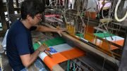 A weaver making unstitched national tricolor in Phulia, Nadia